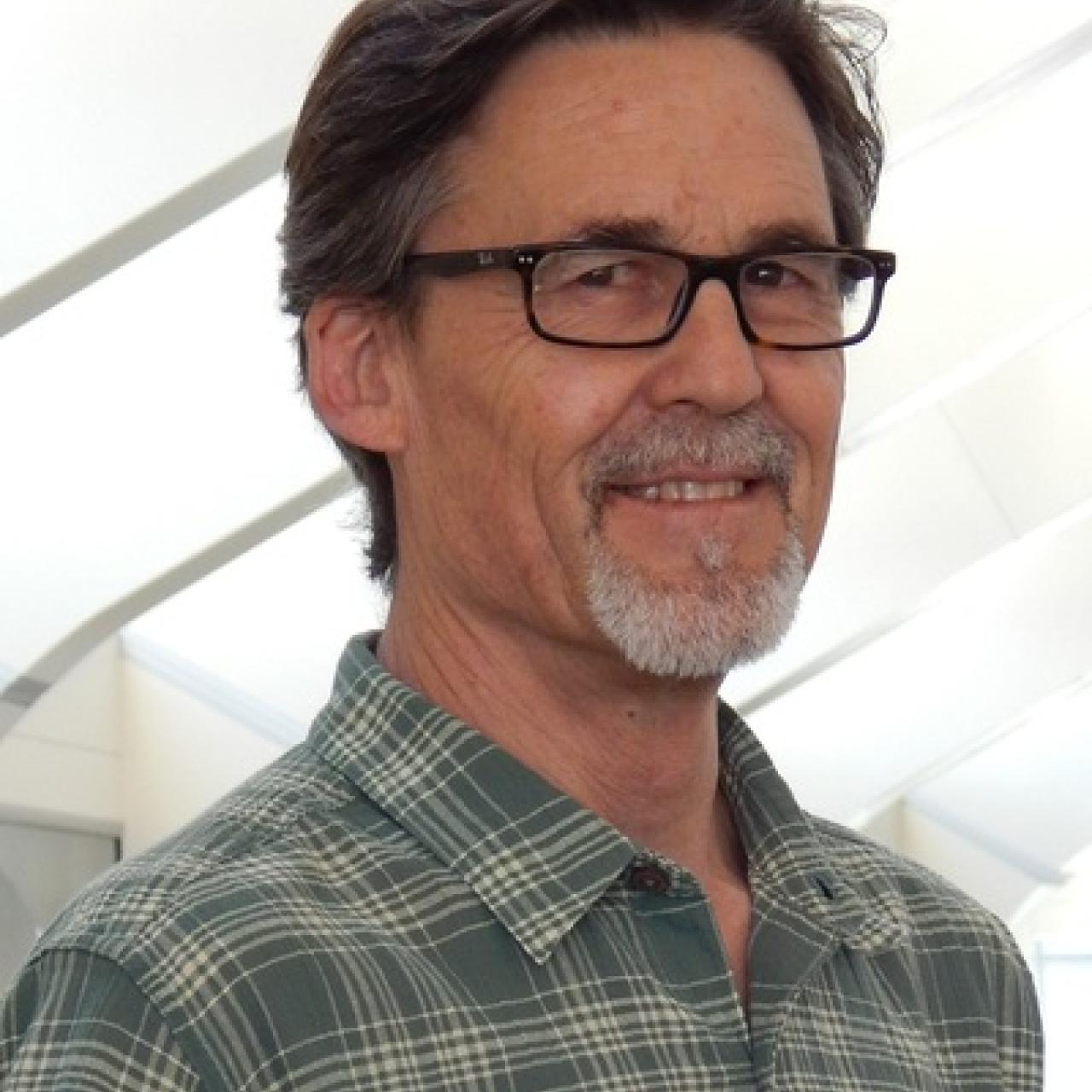 Chris Hammel wearing a green plaid shirt and glasses